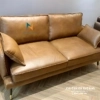 Văng sofa da bò thật 2 tựa dài 1m6, đi kèm là 1 chiếc đôn vuông