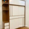Chiếc tủ hiện đại 2 cánh lùa, gỗ mdf, kích thước 2mx2m45, thiết kế 2 tầng, bên trái có kệ trang trí, cánh được dán các đường chỉ decor rất đẹp
