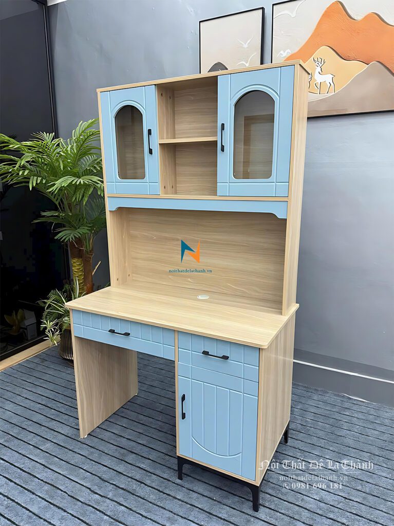 Chiếc bàn học dành cho bé trai, màu 388 pha màu xanh, bàn liền giá sách, giá sách có 3 ô, ô giữa không cánh, 2 ô 2 bên có khoét cánh kính rất đẹp